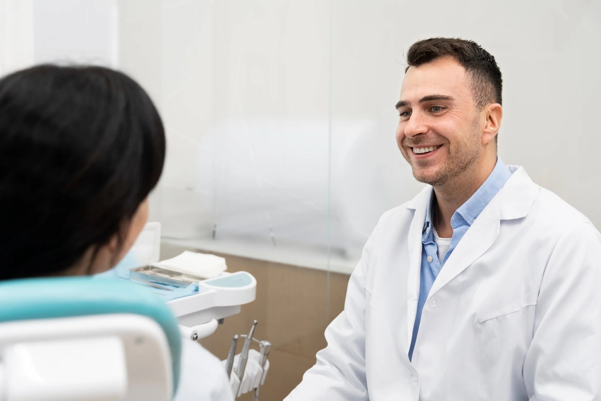 Dentist performing oral health check on patient in dental clinic