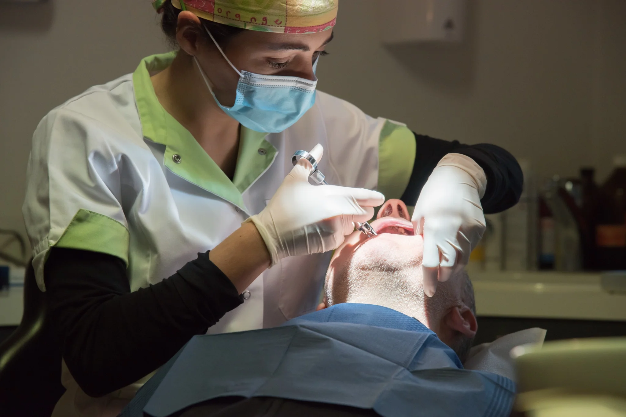 Professional dentist providing dental treatment in a modern dental clinic