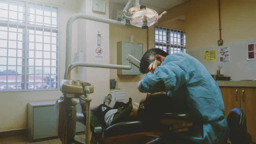 Dentist examining patient teeth during routine dental checkup