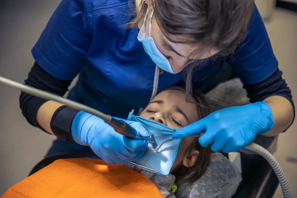 Dentist performing detailed oral examination for patient