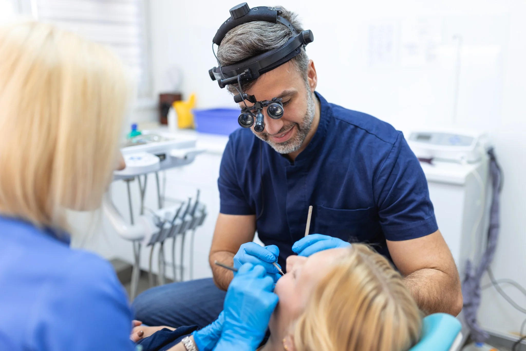 Family dentist examining patient during routine dental checkup in Fresno