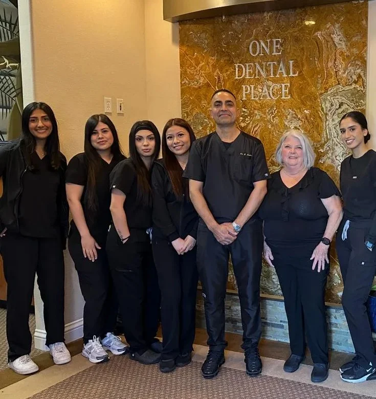One Dental Place Fresno team with dentist and staff inside the clinic lobby